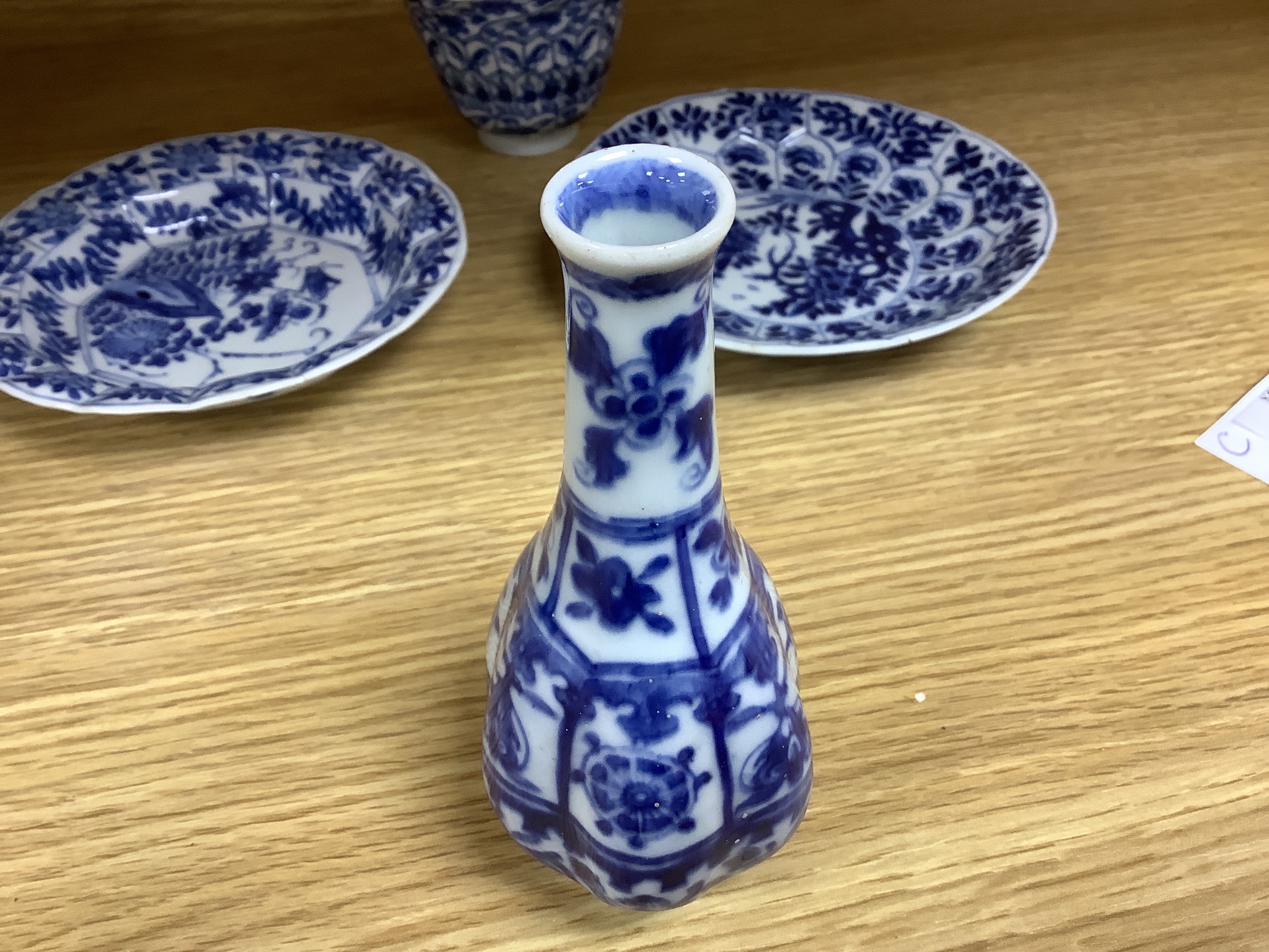 A Chinese blue and white plate 13cm diameter, a similar tea bowl and saucer, Kangxi period and a 19th century Chinese blue and white bottle vase